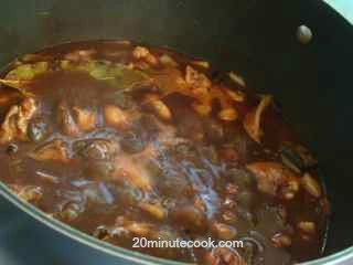 The sauce for the coq au vin thickens on simmering