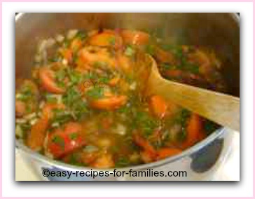 tomatoes and herbs cooking for this easy tomato soup