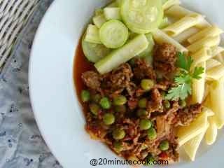 Savory easy ground beef recipe plated with short pasta and salad.