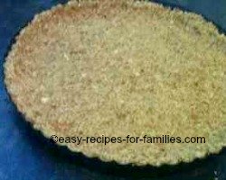 Press the crumbs firmly into the base and sides of the flan pan