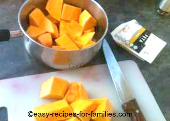 Diced pumpkin pieces in a saucepan