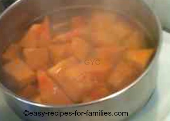 Stew the prepared pumpkin pieces in salted water